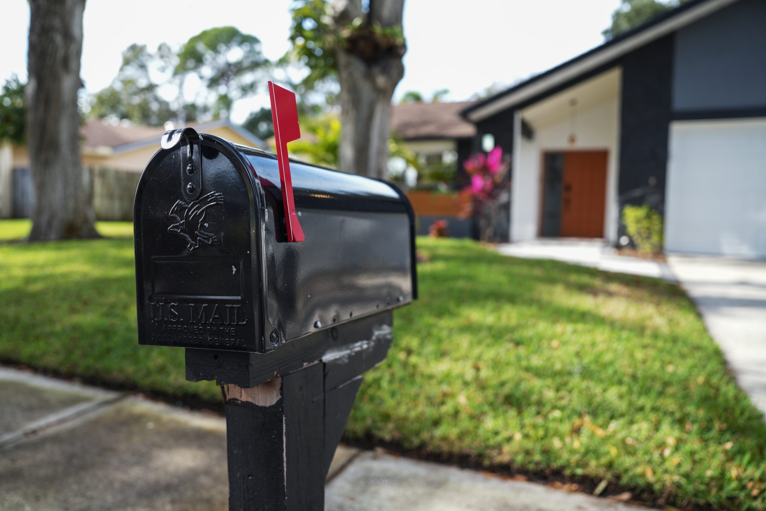 Black mailbox in front of house