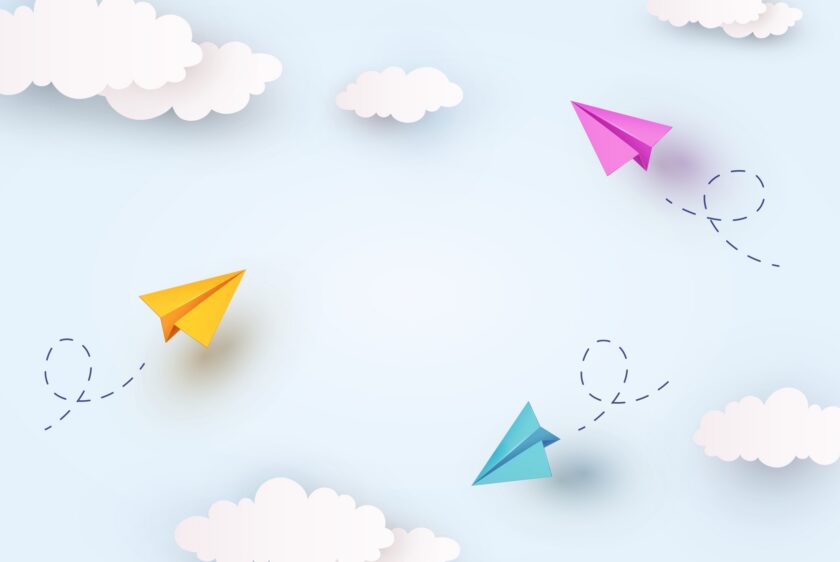three paper planes flying in the air 